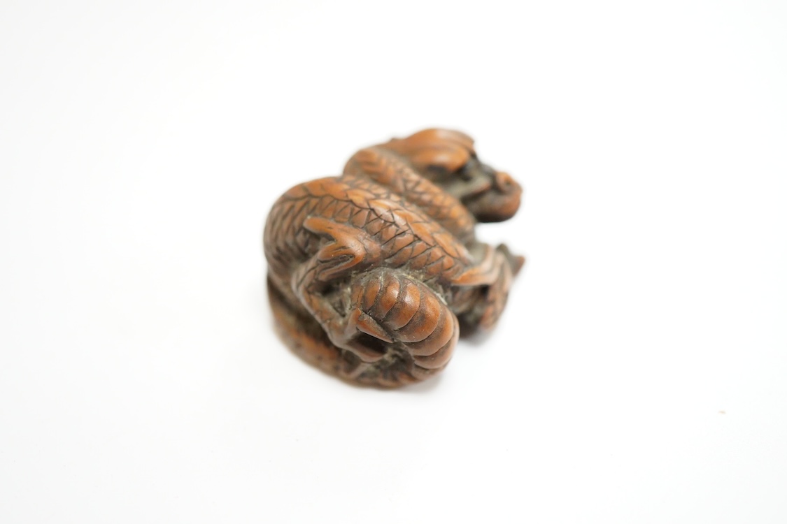 A 19th century Japanese carved wood ‘dragon’ netsuke, 4cm wide